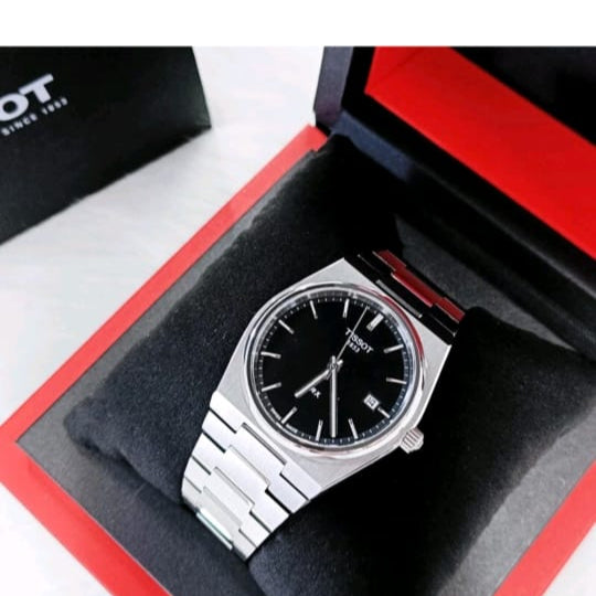 Silver watch in a red and black box